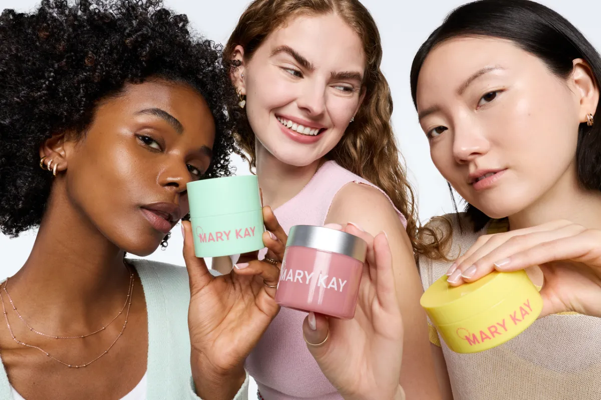 Women holding colorful cosmetics products